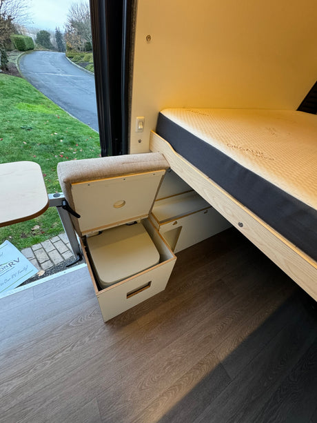 Explore this RV rental's clever interior: organic cotton bed, adjustable table, and hidden pull-out toilet.