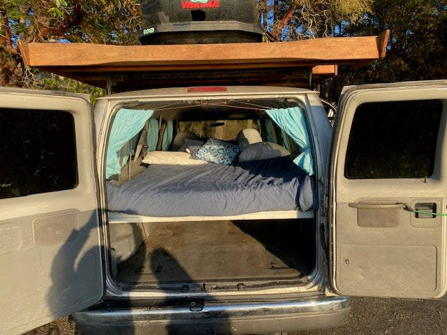 Explore in comfort with this RV rental van! Features a built-in bed & roof cargo, ideal for camping and travel.