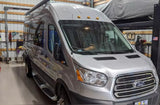 Silver Ford Transit van, a spacious campervan, ready for RV rental adventures.