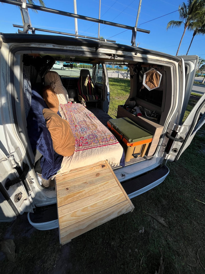  and fishing rods for adventure.|An RV rental's inviting interior: bed — photo 12
