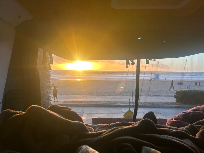 Enjoy a stunning beach sunset from this comfy RV rental. Watch people stroll the sandy shore near the ocean. — photo 6