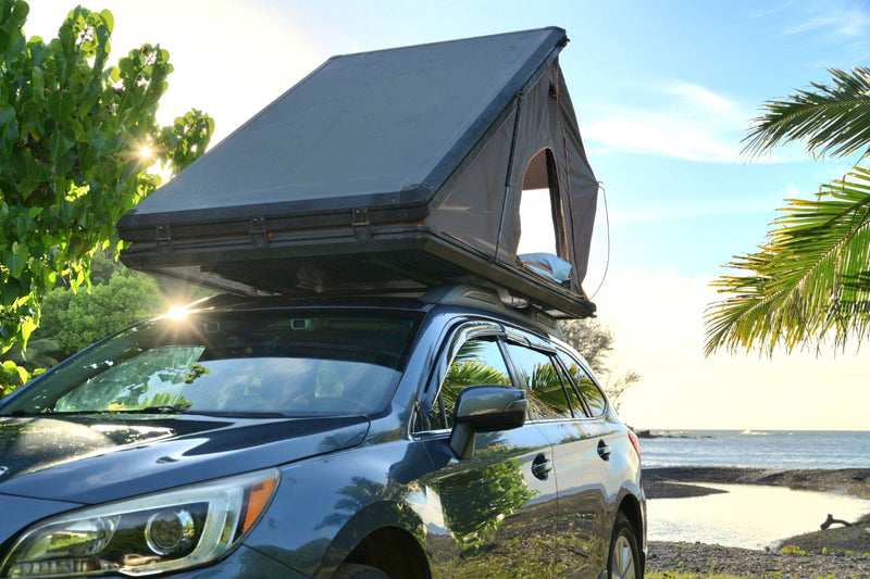  is set for beachside camping under a vibrant sunset.|Cozy RV rental bed with white pillows and a grey blanket — photo 3