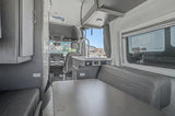 Step inside this rv rental's modern interior with a cozy dining area and kitchen.