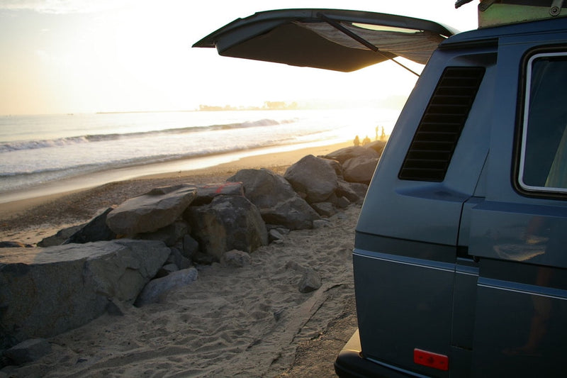  overlooking the beach. An ideal rv rental for family adventures.|Beachside RV rental van with open hatch — photo 4