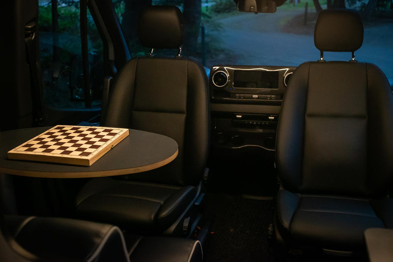  plus a comfy bed. Outside nature view through screen.|RV rental interior shows a compact kitchenette with sink — photo 3