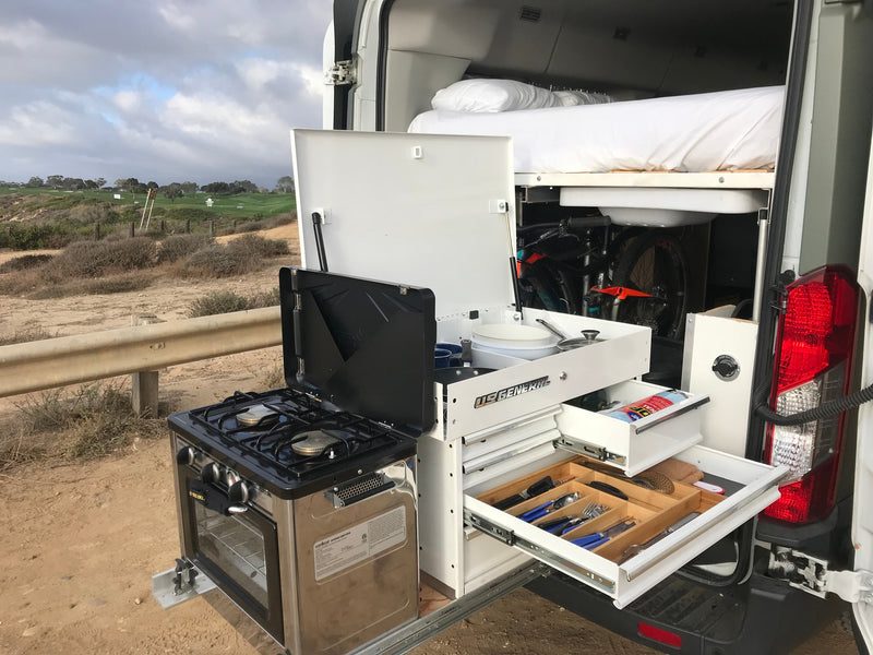 RV rental: Versatile camper van with outdoor pull-out kitchen, smart storage, bed, & bike space. View of golf course. — photo 2