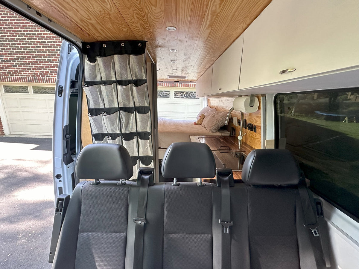 Step inside this RV rental! A custom camper van interior with rear seats