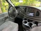 RV rental interior: Dashboard, steering wheel, radio, climate controls, & cupholders visible from the driver's seat.
