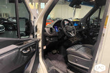 Inside a premium RV rental: Mercedes-Benz Sprinter driver's area featuring quilted leather and high-tech dashboard.