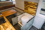 Explore this RV rental's clever design: a versatile dinette, cozy seating, and a hidden, lift-up toilet maximize space for travel.