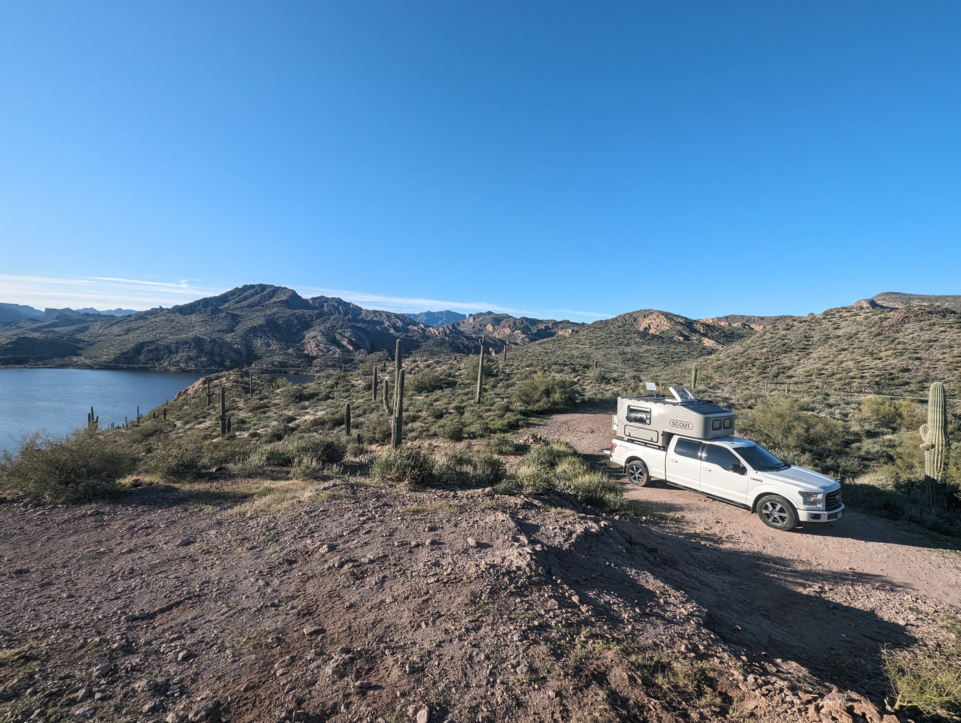 White truck with RV camper parked by desert lake & mountains. Ideal for an RV rental outdoor adventure. — photo 2