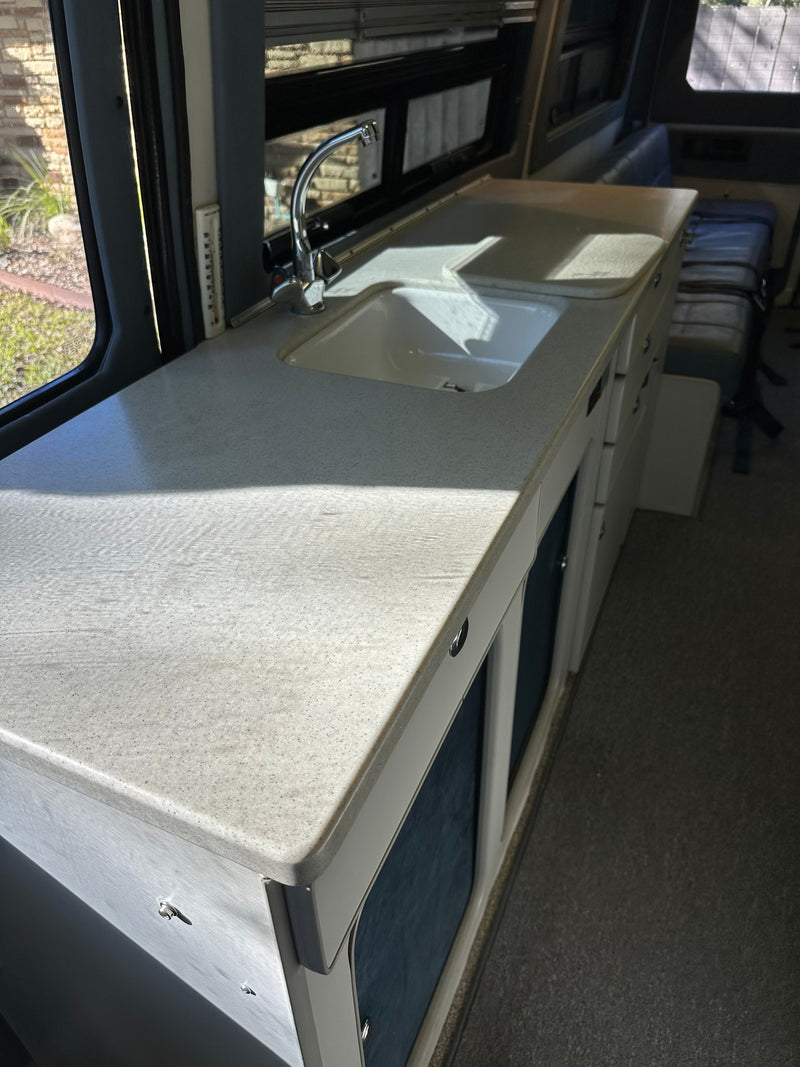  and overhead cabinets.|Compact RV rental kitchen with a counter — photo 7