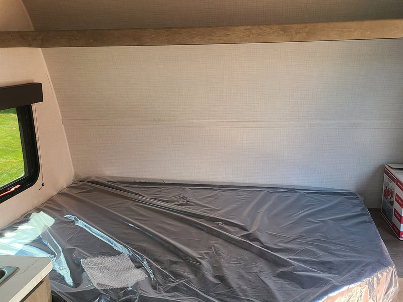 next to a cozy bunk bed.|Grey mattress on a built-in bunk bed in an RV rental — photo 6