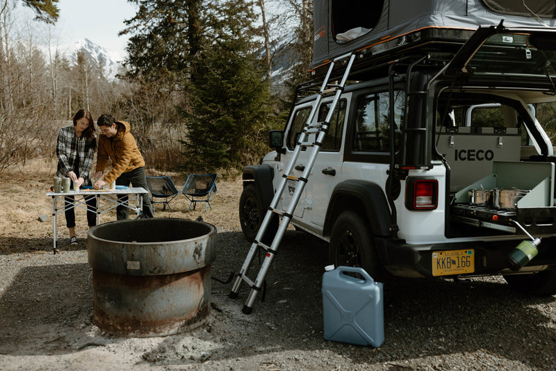 Prepping a meal on an RV rental overlanding Jeep with a roof top tent in Alaska. Perfect for outdoor adventure. — photo 6