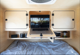 Cozy RV rental bedroom features a built-in laptop desk, ample storage, and a comfy bed for digital nomads.