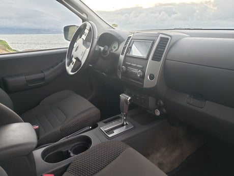 View from a spacious SUV interior, dashboard & seats visible, with a stunning ocean vista. Ideal for your next travel or **rv rental** adventure!
