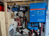 Detailed RV rental electrical system: Victron MultiPlus inverter, Cerbo GX, and WS500 alternator regulator for off-grid power.