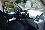 Spacious RV rental van interior, featuring the driver's cabin, dashboard, steering wheel, and front seats.
