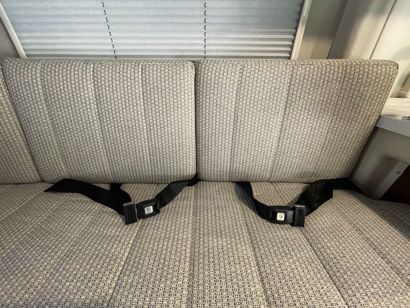  parked on gravel near a bright yellow building.|Dashboard of an RV rental — photo 17