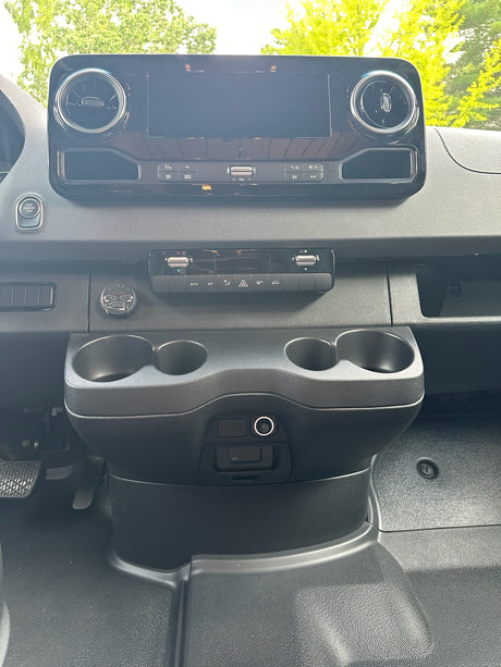 RV rental van cockpit: touchscreen, climate control, start/stop button, USB ports, and cup holders for your journey.