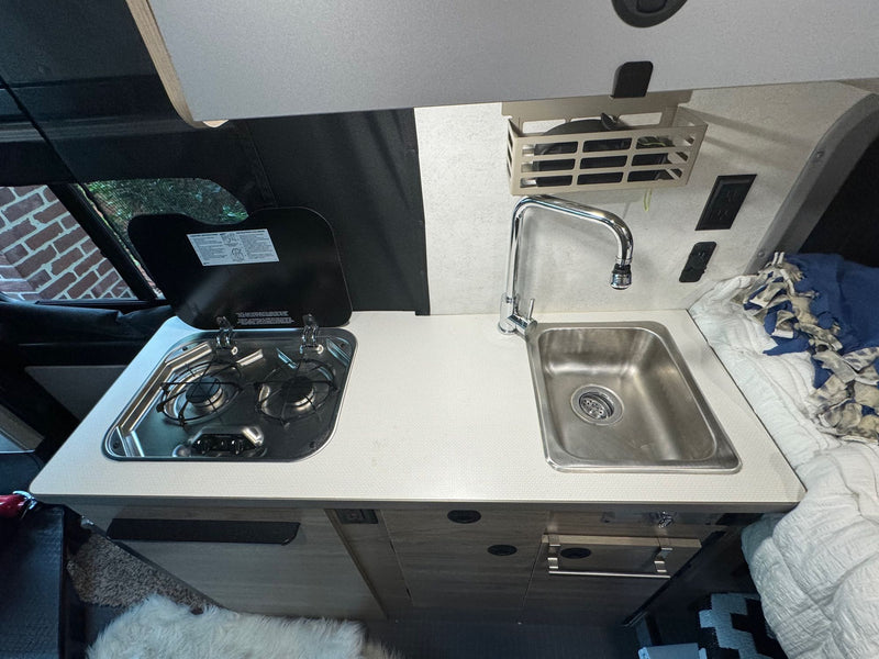  and control panels for comfortable travel.|Bright RV rental interior with a cozy bed — photo 11