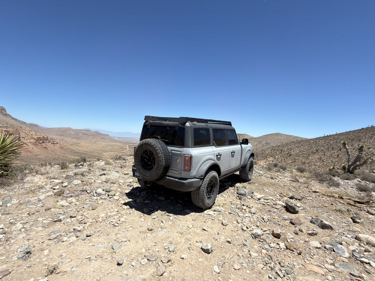 explore beyond an rv rental.|Dirty Goodyear Territory RT tire and black wheel with a Bronco logo — photo 6