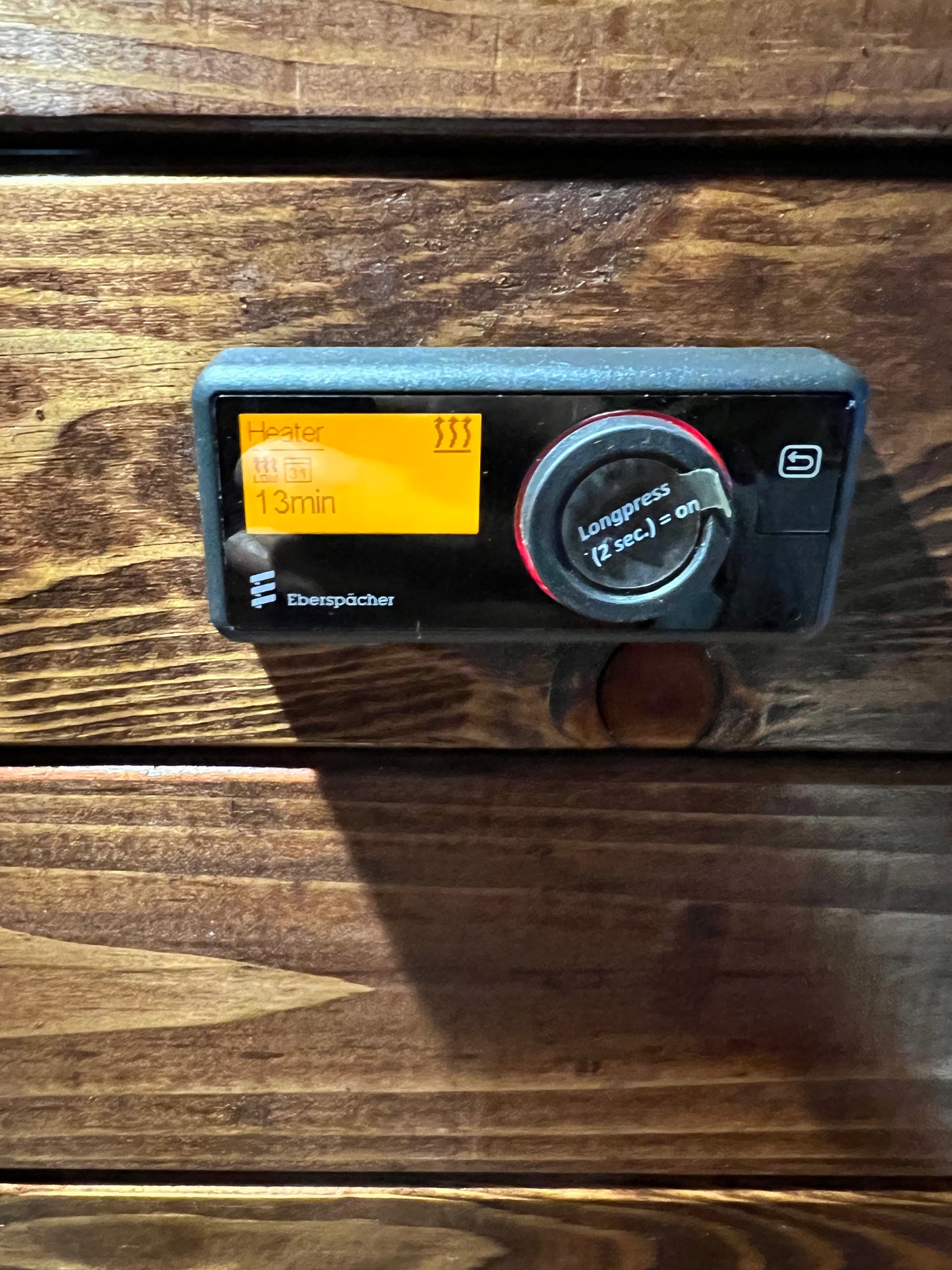 This Eberspächer heater control panel, ideal for an RV rental, shows 'Heater' and '13min' on its display. Long-press the dial to turn on.