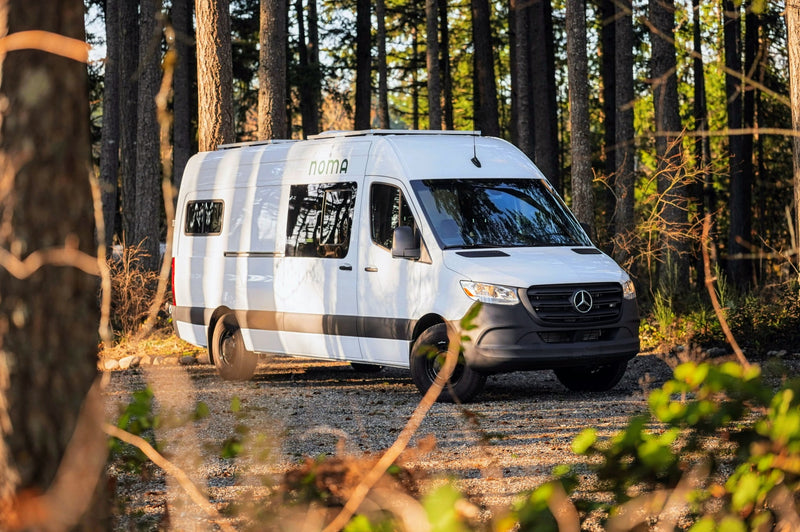White Mercedes Sprinter camper van (Noma RV rental) parked in a sun-drenched forest. Perfect for adventures. — photo 16