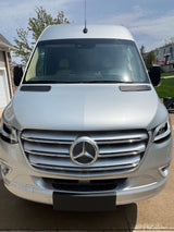 Sleek silver Mercedes-Benz Sprinter van, ideal for RV rental. Full front view of this versatile travel vehicle.