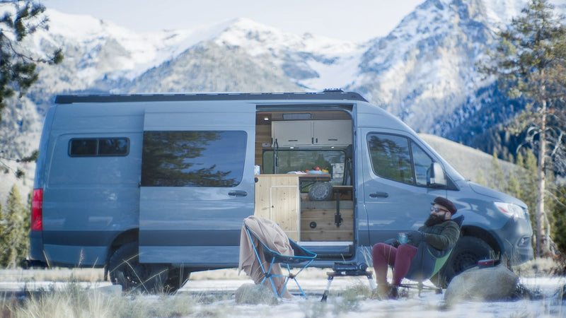  and cozy bed setup.|RV rental van interior with front seats — photo 1
