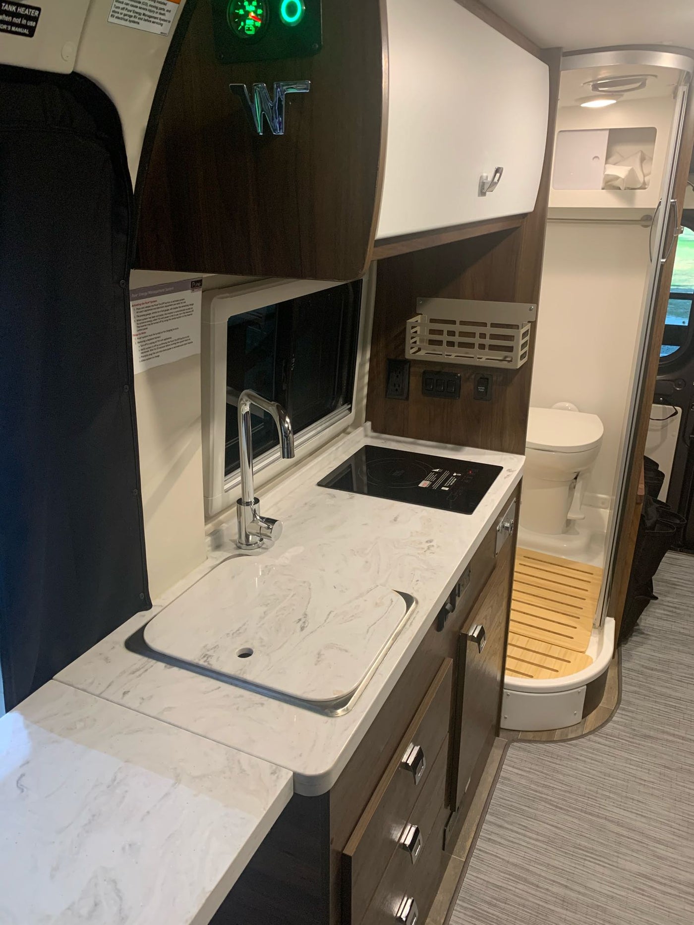  and microwave. Compact comfort for adventures.|Explore this RV rental's interior: cream swiveling front seats — photo 4