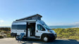 Scenic RV rental adventure by the ocean. Camper van with open door