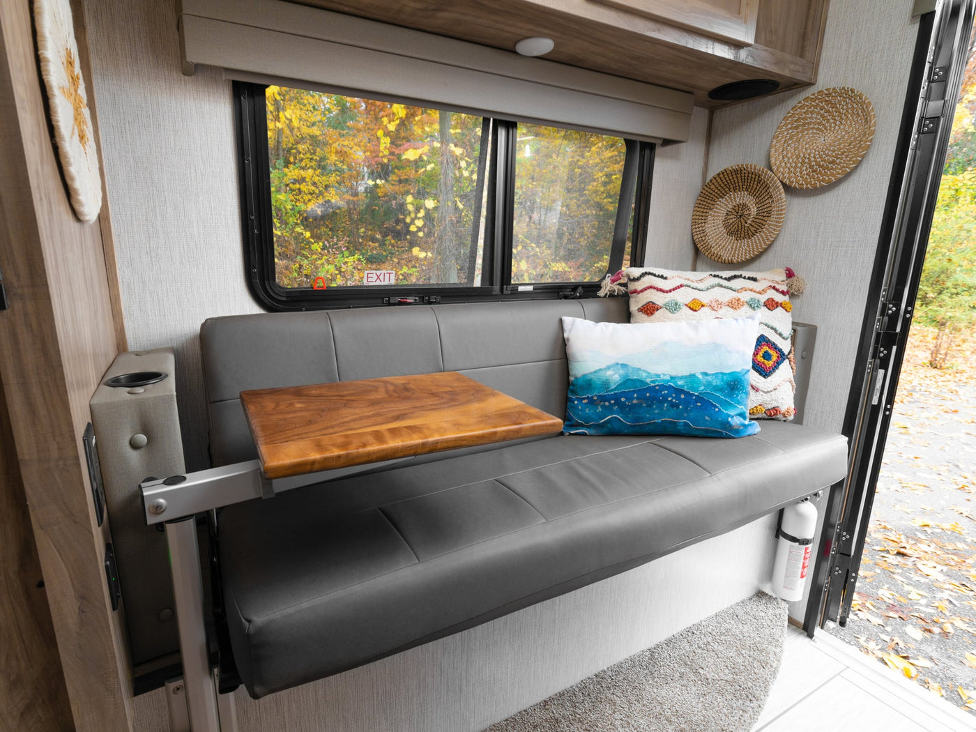  ideal for dining or relaxation.|Cozy RV rental interior with a grey fold-down bench-bed — photo 5