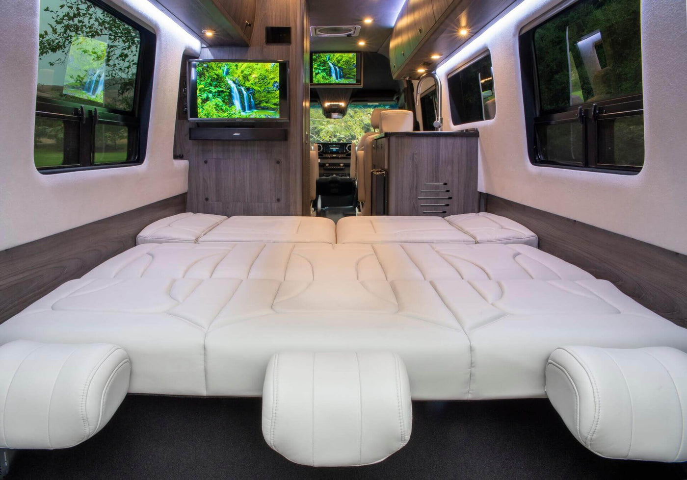  ideal for relaxing travel.|Cozy bed with white linens and a picturesque mountain view from your RV rental.|An elegant RV rental interior — photo 4