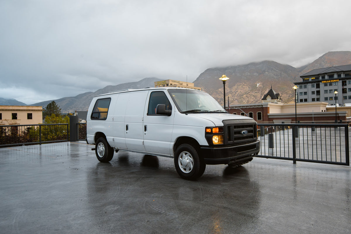  wood-paneled ceiling & walls.|A white van — photo 3