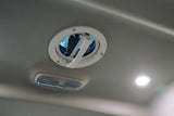Inside an RV rental: Ceiling with a circular pop-up vent, rectangular light fixture, and bright recessed LED light.