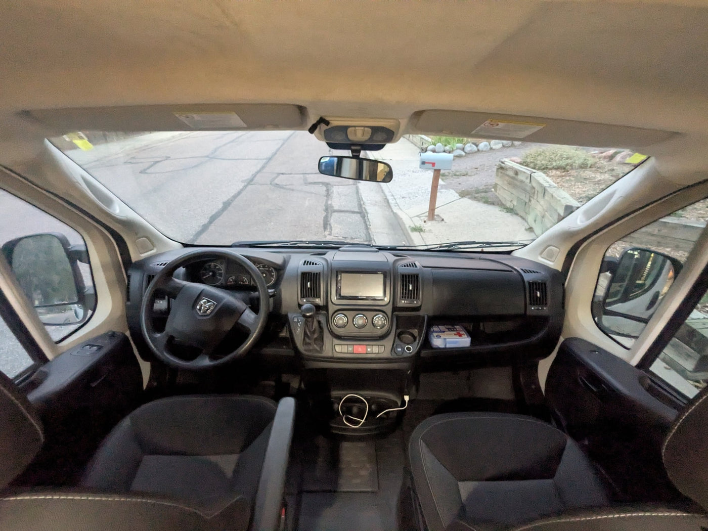  tiled backsplash & driver's cabin. Explore van life comfort.|RV rental van cockpit with Ram steering wheel — photo 14