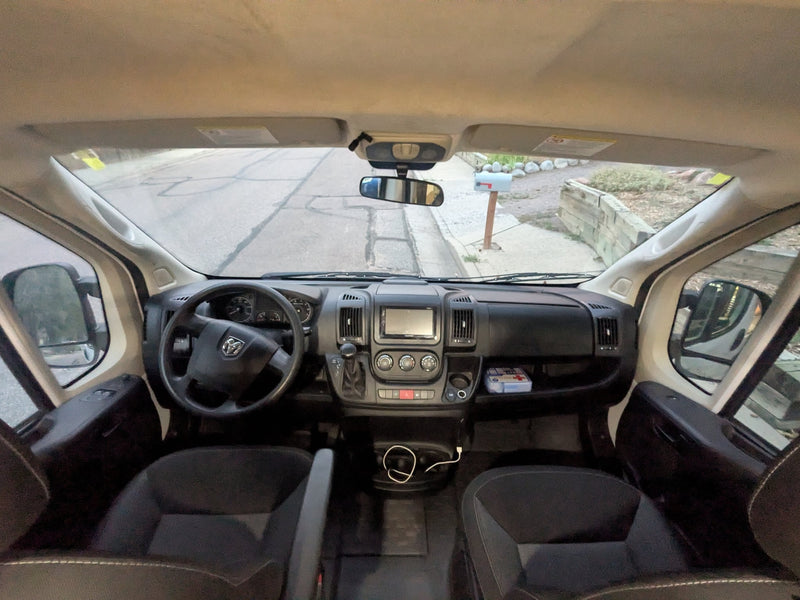  tiled backsplash & driver's cabin. Explore van life comfort.|RV rental van cockpit with Ram steering wheel — photo 14