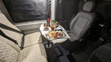 Cozy RV rental interior: A charcuterie board, wine, and comfortable seating arranged for an intimate meal.