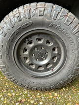 A durable off-road tire and black wheel, ready for any rv rental adventure. Nitto Ridge Grappler LT285/75R17 shown.