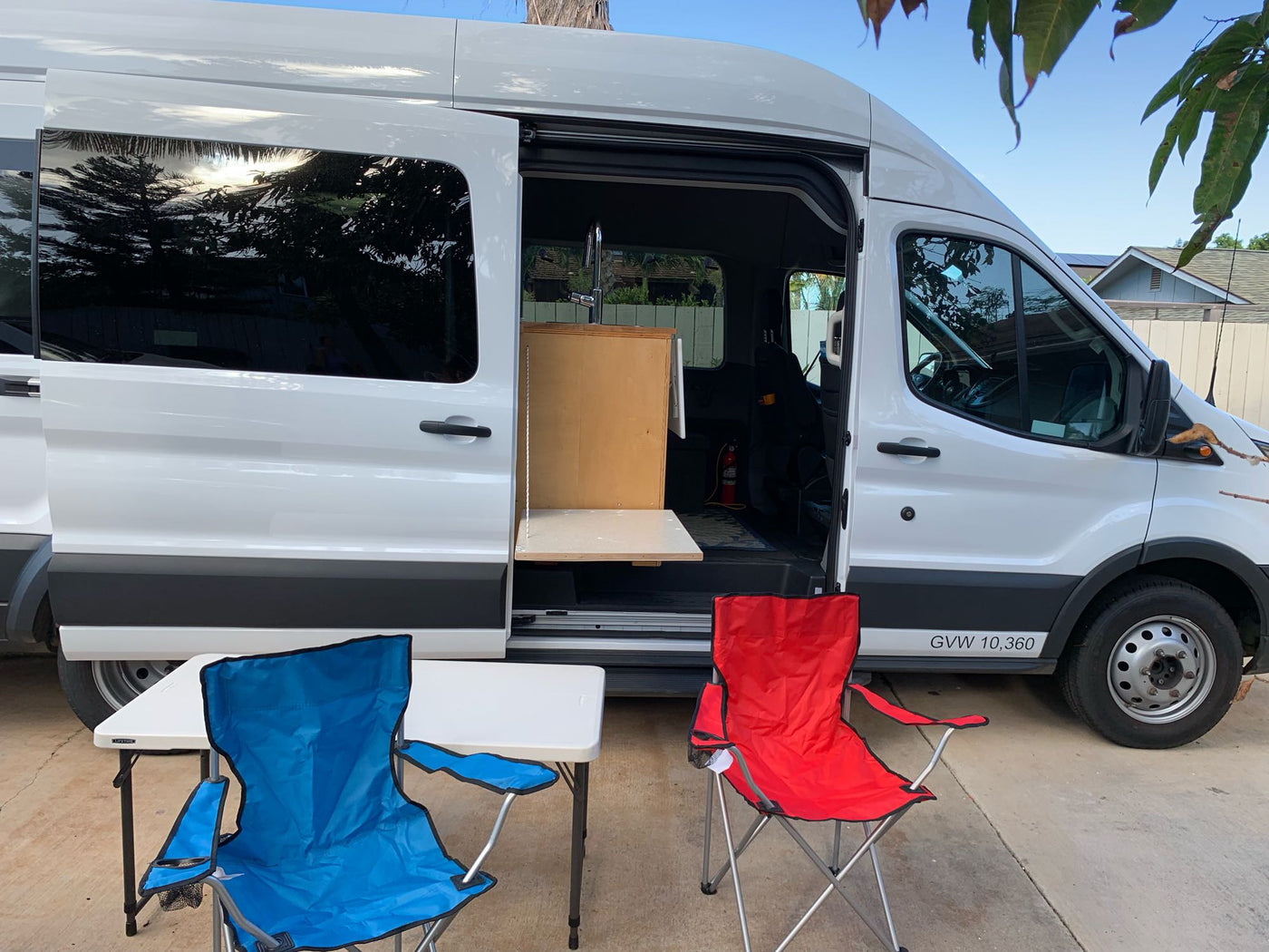  & fuel cans for off-grid power.|View inside an rv rental camper van: front seats — photo 3