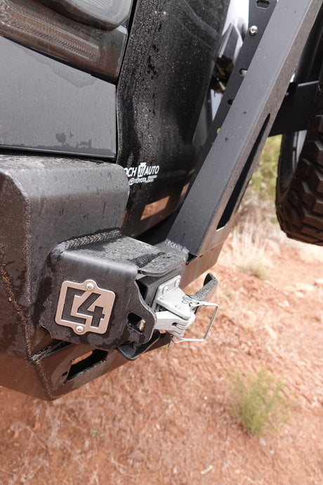 Dusty C4 Fabrication rear bumper & hitch on an off-road vehicle, ready for remote exploration, unlike a typical RV rental.