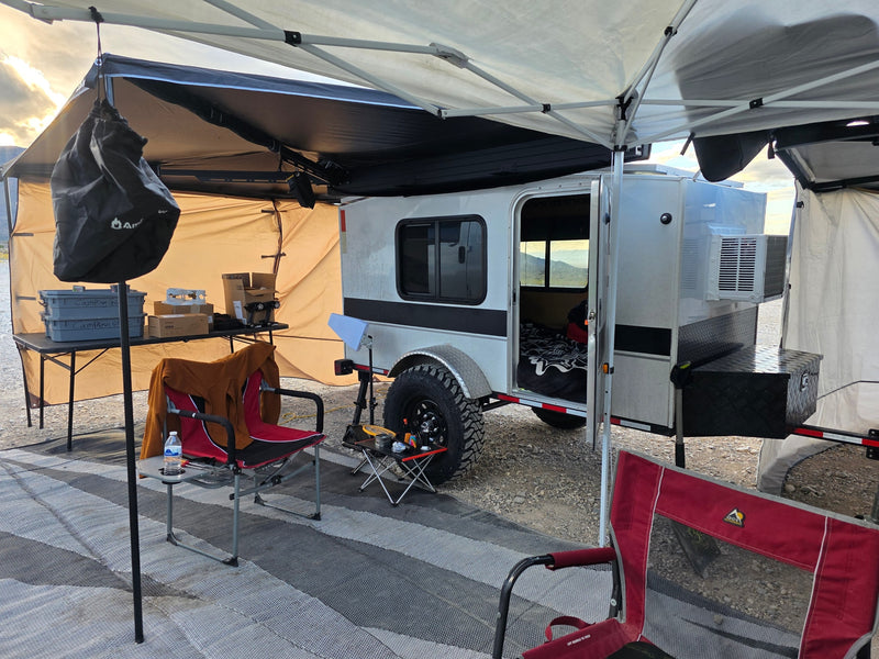  and solar panels in a remote desert landscape.|An RV rental camping site with a silver teardrop trailer — photo 3