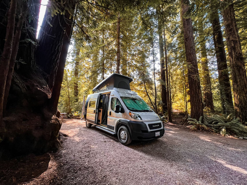  ready for adventure.|A white camper van (RV rental) rests on a sunlit rural road — photo 4