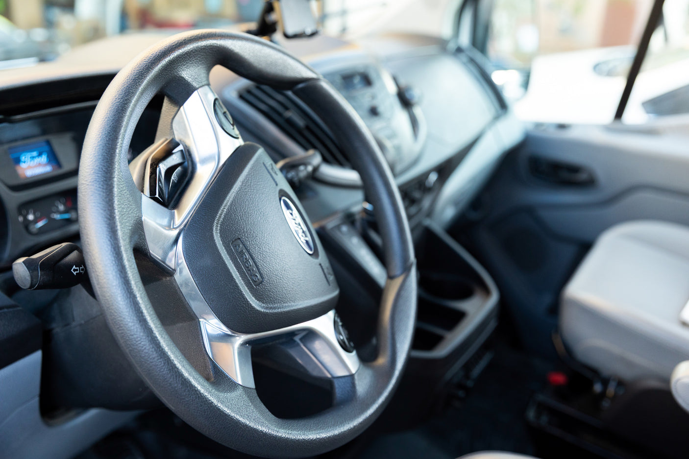 RV rental interior with a clear view of the Ford steering wheel, dashboard display, and driver's seat area.