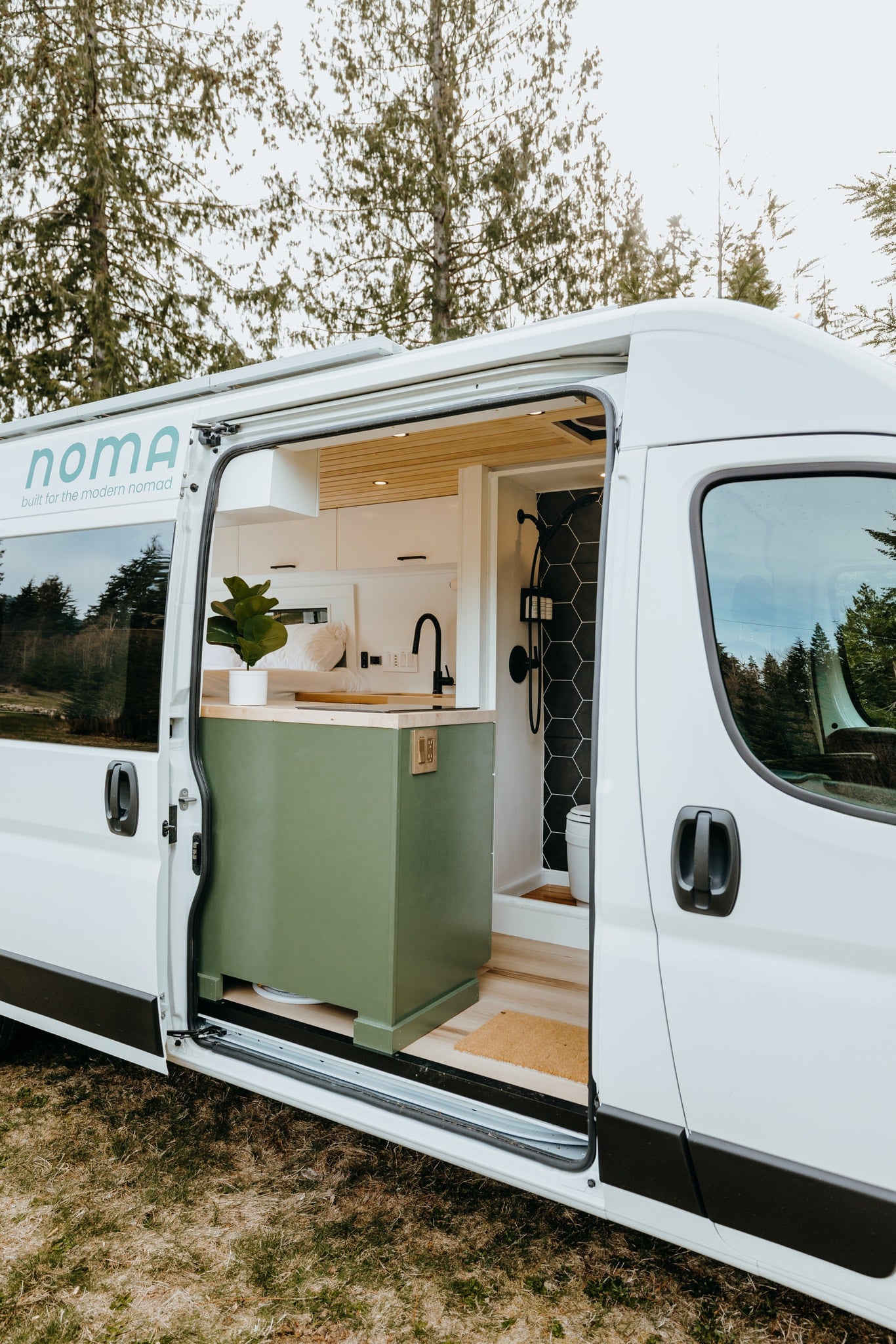 Step inside this modern RV rental! See the sleek kitchen & shower of this ready-for-adventure camper van interior. — photo 10