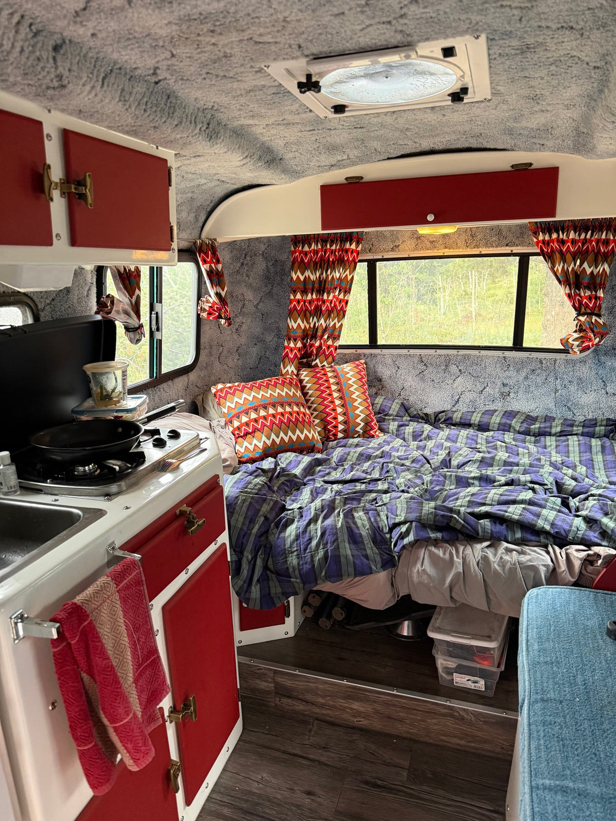  while the other sits at the table.|An inviting RV rental interior — photo 4
