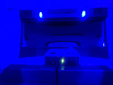 Blue-lit RV rental interior featuring a 'ROVER' display, illuminated controls, and a prominent green light.