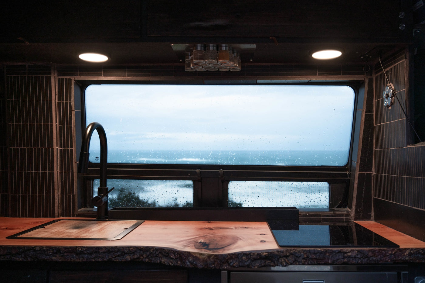  & forest views. Perfect campervan tiny home on wheels.|Cozy RV rental interior with a fully equipped wood kitchen — photo 4