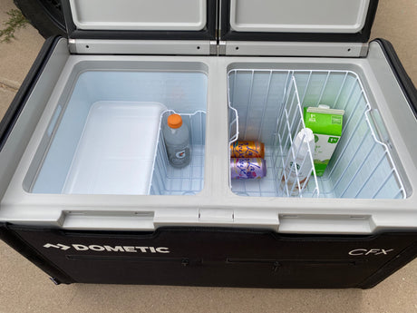 Open Dometic CFX portable cooler/fridge, ideal for an rv rental, showcasing drinks like milk, La Croix, and Gatorade.